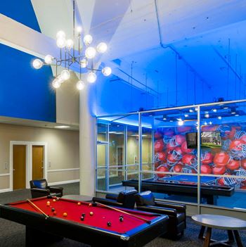 A game lounge featuring billiards, shuffleboard & ping pong